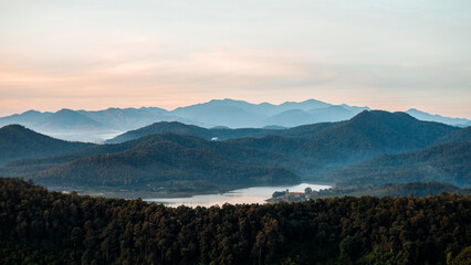 Obraz premium Overlapping mountain landscape in the morning with clouds and fog on the mountain surface.