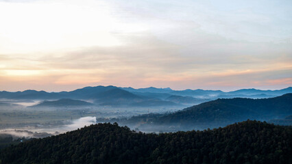 Fototapeta premium Overlapping mountain landscape in the morning with clouds and fog on the mountain surface.