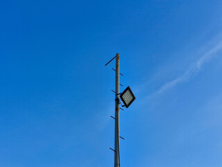 Pole for beach lighting with a bright blue sky background