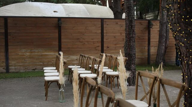 chairs with decor near the arch for a wedding ceremony in the park