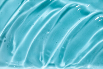 Liquid gel beauty serum texture. Beauty skincare liquid blue gel background with bubbles. Skincare hygiene product closeup.	