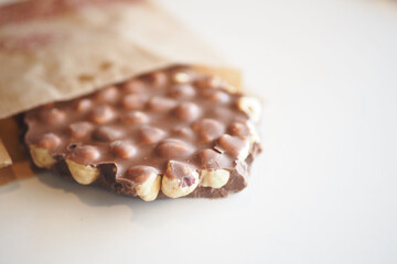 Delicious Chocolate Coated Snack Bar Featuring Nuts and a Delightfully Crispy Texture