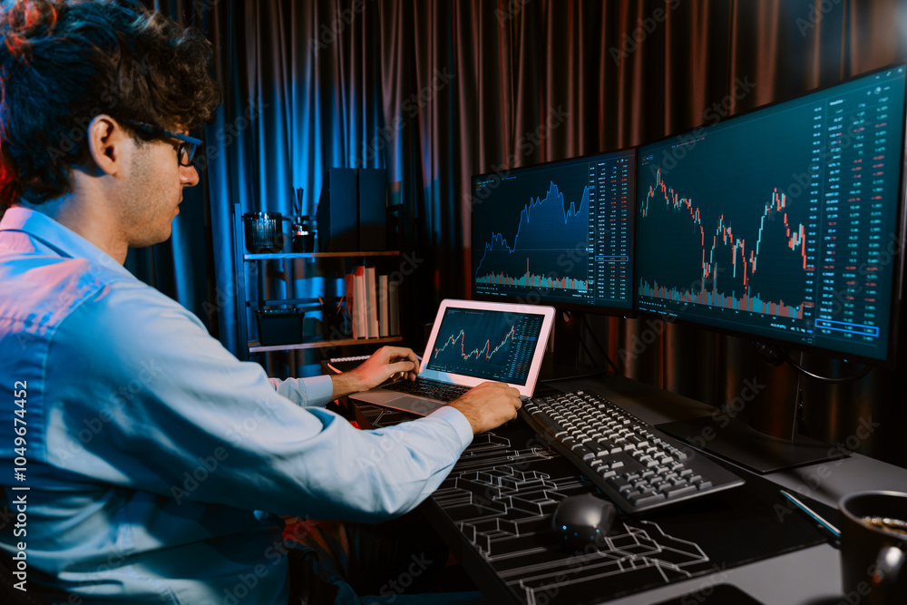 Poster young investor stock trader searching on laptop comparing with dynamic exchange rate screens of curr