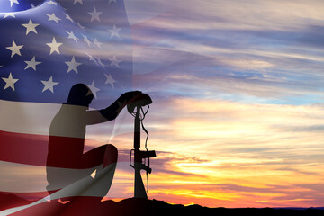 Naklejka premium Silhouette of a soldier kneeling down with USA flag against the sunset. Veterans Day. Honoring All Who Served