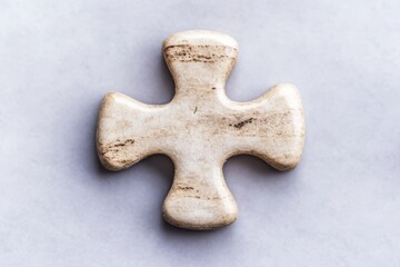 Obraz premium single white jigsaw puzzle piece on blue background with copy space for text and image decoration.