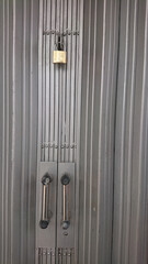 Obraz premium Locked Gray Metal Rolling Door with Industrial Themes Chrome Handles