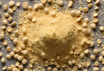 Nutritional yeast flakes, or dry inactive yeast falling background and texture.