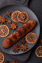 Sweet eclair with chocolate custard sprinkled with cocoa powder
