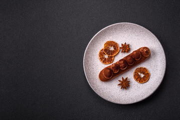 Sweet eclair with chocolate custard sprinkled with cocoa powder