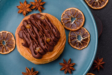 Sweet dessert danish covered with chocolate cream, with cream filling