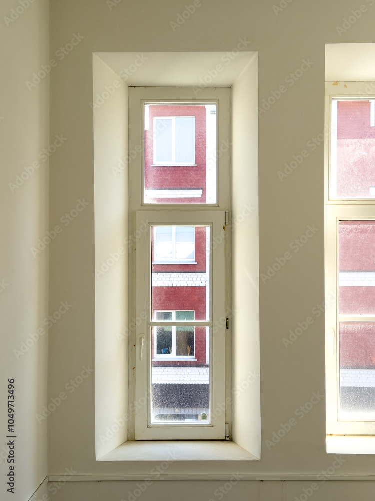 Wall mural A window with a view of a city skyline