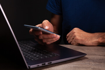 Fototapeta premium shirt works in a modern office. the man is typing on a laptop