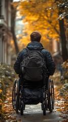 Obraz premium Person in wheelchair enjoying autumn nature stroll