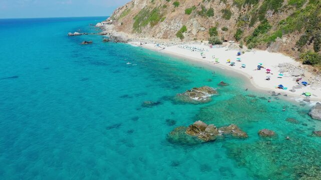 Aerial view of sea and rocky beach in Marinella Di Zambrone on a sunny summer day in Calabria, Italy