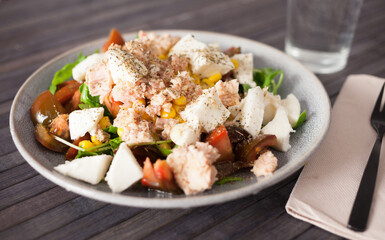 Plate of salad with tuna, corn, tomatoes and arugula