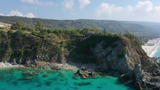 Aerial view of sea and rocky beach in Marinella Di Zambrone on a sunny summer day in Calabria, Italy