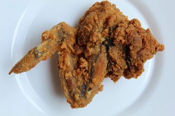 One wing crispy fried chicken, on white plate, isolated in white background, flat lay or top view