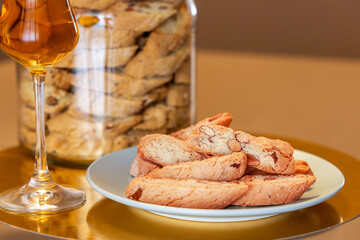 Crispy almond cantucci served with Vin Santo dessert wine, offering a classic Italian pairing,...