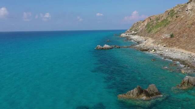 Aerial view of sea and rocky beach in Marinella Di Zambrone on a sunny summer day in Calabria, Italy