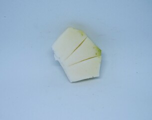 pieces of young, still white mango fruit, on a white background