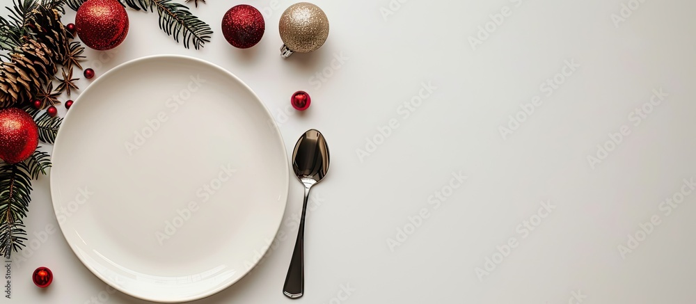 Poster Isolated Christmas plate with decorations along with a fork and spoon New Year holiday backdrop Top view. with copy space image. Place for adding text or design