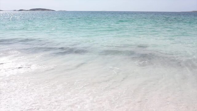 Clear blue waters of the sea with waves lapping onto the white sands. Paradise scene. Taken at Hellfire Bay, Cape Le Grand, Western Australia