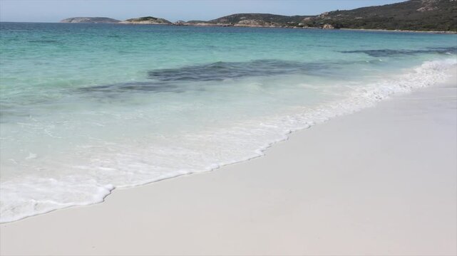 Clear blue waters of the sea with waves lapping onto the white sands. Paradise scene. Taken at Hellfire Bay, Cape Le Grand, Western Australia
