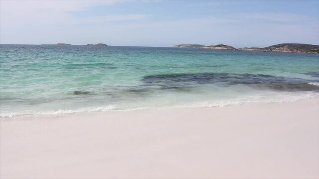 Clear blue waters of the sea with waves lapping onto the white sands. Paradise scene. Taken at Hellfire Bay, Cape Le Grand, Western Australia