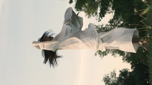 ancing in the open air, the woman moves with grace and purpose, her flowing gestures symbolizing the freedom and emotional depth that come from being in harmony with nature.