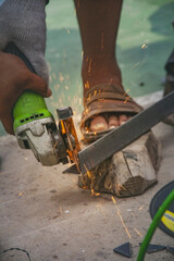 worker cutting wood with chainsaw, Technician cutting for steel structure at manufacture workshop.