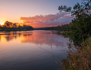 Fototapeta premium Sunset Over the River with Reflections