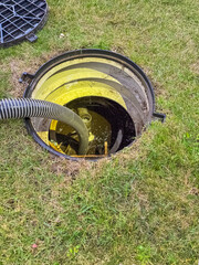 opened the sewer hatch and inserted a hose for cleaning the septic tank. High quality photo