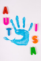 Kid handprint made of paint on white background. Autism spectrum disorder. Autism awareness