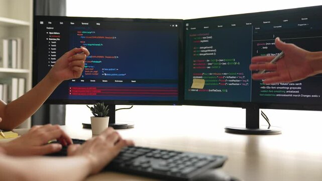 Back end software developer engineer for computer programming working together on debugging writing computing code, solving complex algorithms display on monitor in office. Burgeoning
