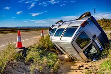 An old crashed van on the side of a road