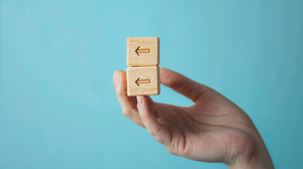 hand and a box with an arrow on the blue wall