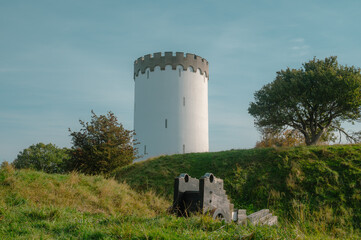 Watch tower on hill from olden days with a canon in front
