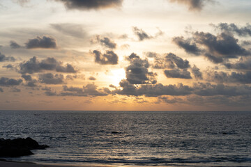 Serene Sunset Over the Ocean with Dramatic Clouds in the Sky