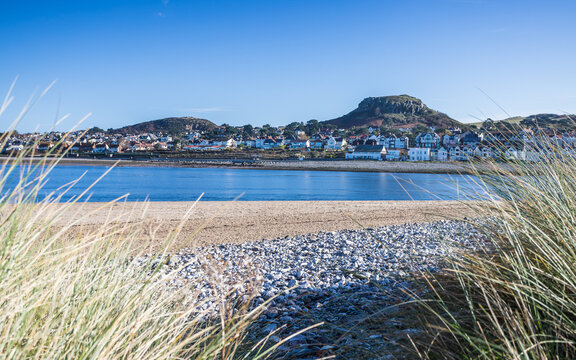 Deganwy seafront framed by dune grass