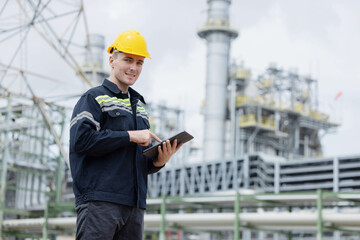 Petroleum engineer working with tablet  at oil refinery site