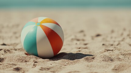 Obraz premium Colorful Beach Ball on Sandy Shore