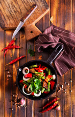 vegetable stew in pan on wooden table