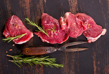 raw beaf on a dark wooden table.