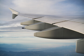view of airplane wing during flight in midday