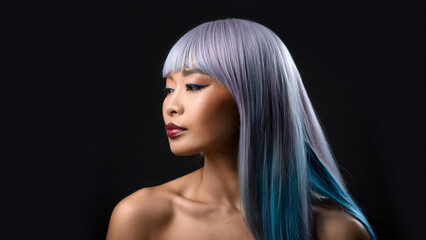 Close up professional fashion studio portrait of a person woman on black background with colored hair