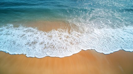 Aerial View of Tranquil Ocean Waves Gently Washing Over Serene Sandy Beach