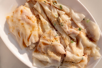 top view traditonal Cantonese food of cheong fun or rice noodle rolls or steamed vermicelli rolls horizontal composition