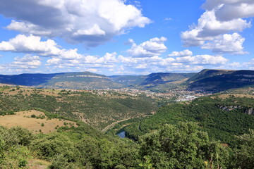 Fototapeta premium Landscape of Millau, France. Mountains and blue sky with white clouds, Gorges du Tarn