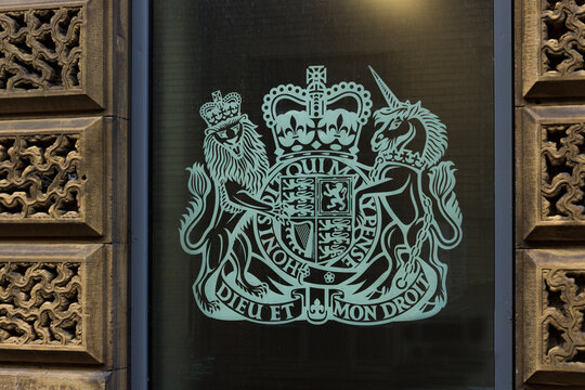 Coat of arms with crowned lion and unicorn, Royal Standard and Dieu et Mon Droit and Honi Soi Qui Mal Y Pense messages at the entrance to Bradford's Coroner's Court