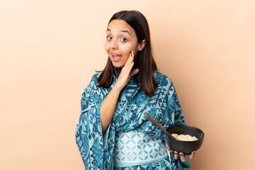 Woman wearing kimono and holding a bowl full of noodles whispering something while holding a bowl...